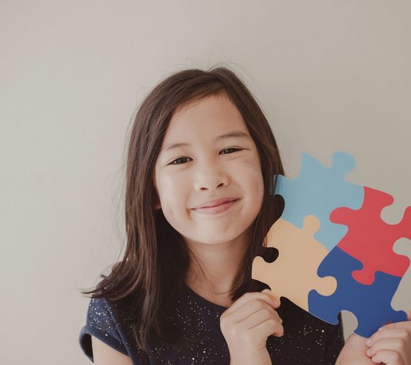Young girl holding puzzle jigsaw,  child mental health concept, world autism awareness day, autism spectrum disorder awareness concept
